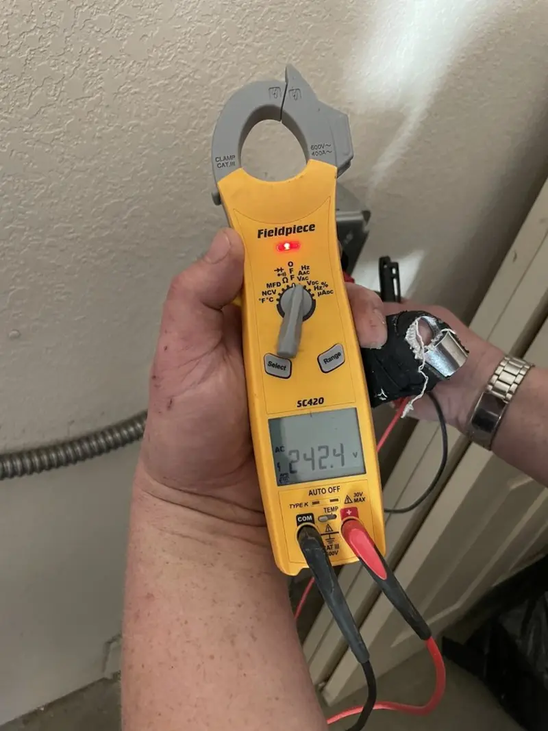 Voltage testing with clamp meter during Electrical Installation Services in Sonora